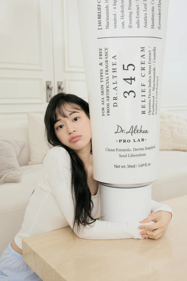 Woman applying skincare product