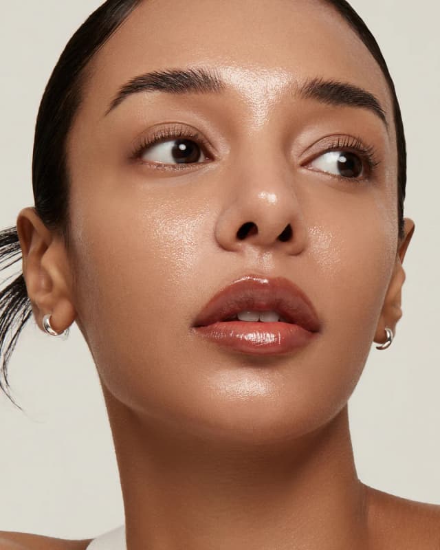 Woman applying skincare product